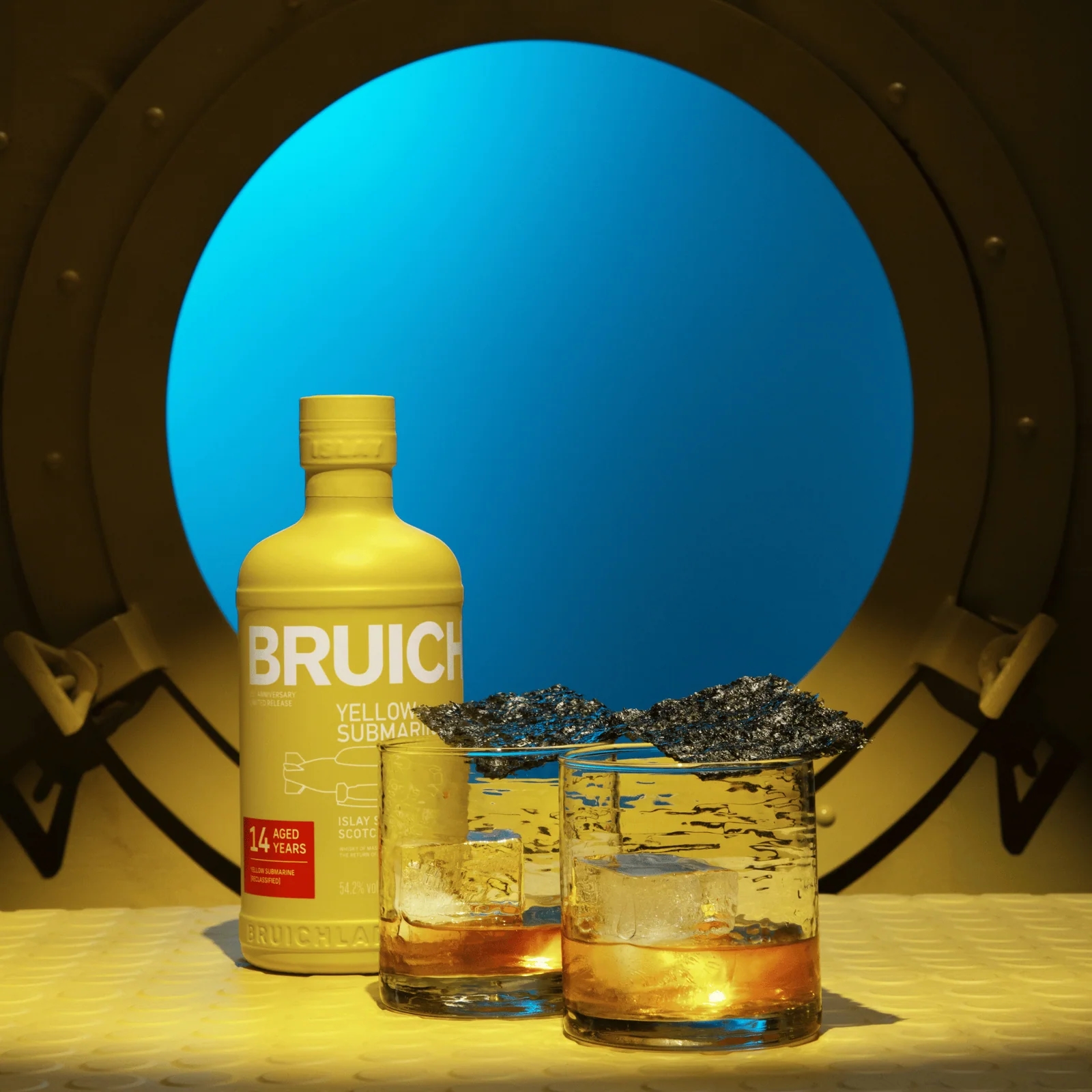 Bruichladdich Yellow Submarine whisky cocktails served in a rocks glass by a porthole
